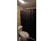 Bathroom featuring a decorative toilet and a black shower curtain at 6717 Sheffield Dr, Las Vegas, NV 89108