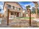 Backyard featuring a wooden deck, artificial grass and desert landscaping at 6938 Silk Oak Ct, Las Vegas, NV 89148