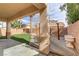 Backyard featuring a wooden deck, artificial grass and desert landscaping at 6938 Silk Oak Ct, Las Vegas, NV 89148