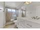 Bathroom features a walk-in shower with glass doors, a double vanity with a white countertop at 6938 Silk Oak Ct, Las Vegas, NV 89148