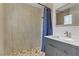 Modern bathroom featuring a walk-in shower, vanity with gray cabinets, and patterned tile floors at 6938 Silk Oak Ct, Las Vegas, NV 89148