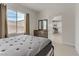 Bedroom featuring a comfortable bed, a dresser, and a window with backyard views at 6938 Silk Oak Ct, Las Vegas, NV 89148