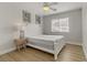 Bright bedroom featuring a white wooden bed frame, ceiling fan, and wood-look flooring at 6938 Silk Oak Ct, Las Vegas, NV 89148