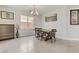 Dining room featuring a modern chandelier and a large picture window at 6938 Silk Oak Ct, Las Vegas, NV 89148