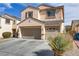 A well-maintained home with a three-car garage and landscaped front yard at 6938 Silk Oak Ct, Las Vegas, NV 89148