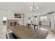 Open-concept kitchen and dining area with stainless steel appliances and brick fireplace at 6938 Silk Oak Ct, Las Vegas, NV 89148