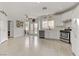 Bright kitchen with stainless steel appliances, white cabinets, and ample counter space at 6938 Silk Oak Ct, Las Vegas, NV 89148