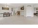 Spacious living room with a stone fireplace, dining area, and bright tile flooring at 6938 Silk Oak Ct, Las Vegas, NV 89148