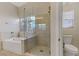 Bathroom featuring a soaking tub and glass shower at 6938 Silk Oak Ct, Las Vegas, NV 89148