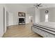 Bright main bedroom with wood floors, ceiling fan, and ensuite bathroom at 6938 Silk Oak Ct, Las Vegas, NV 89148