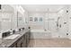 Bright bathroom featuring marble countertops, a soaking tub, and a glass-enclosed shower at 7165 N Grand Canyon Dr, Las Vegas, NV 89149