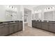 Double vanity bathroom with gray cabinets, granite countertops, and wood-look flooring at 7165 N Grand Canyon Dr, Las Vegas, NV 89149