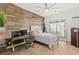 Stylish bedroom featuring a wood accent wall, a desk, and a sliding door at 7165 N Grand Canyon Dr, Las Vegas, NV 89149