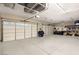 Spacious three car garage with epoxy floors and overhead storage racks at 7165 N Grand Canyon Dr, Las Vegas, NV 89149