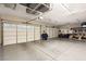 Spacious three car garage with epoxy floors and overhead storage racks at 7165 N Grand Canyon Dr, Las Vegas, NV 89149