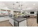 Open kitchen with stainless appliances, granite countertops, and views into the living room at 7165 N Grand Canyon Dr, Las Vegas, NV 89149