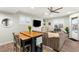 Bright living room featuring hardwood floors, ceiling fan, and a comfortable sofa, and attached kitchen island at 7165 N Grand Canyon Dr, Las Vegas, NV 89149