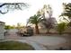 Landscaped backyard featuring palm trees, a sand area, and a utility shed at 7444 Grassy Field Ct, Las Vegas, NV 89131