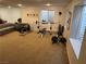 Finished basement featuring home gym area, carpeting, and bright window lighting at 7444 Grassy Field Ct, Las Vegas, NV 89131