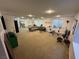 Large finished basement with carpet, gym equipment, and seating arrangement at 7444 Grassy Field Ct, Las Vegas, NV 89131