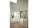 Bright bathroom featuring corner tub, a large window, and glass shower at 7444 Grassy Field Ct, Las Vegas, NV 89131