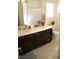 Bathroom features a dark vanity with a tiled countertop and a window at 7444 Grassy Field Ct, Las Vegas, NV 89131