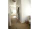 This hallway features carpeted floors and leads to a bathroom with a corner tub at 7444 Grassy Field Ct, Las Vegas, NV 89131