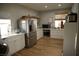 Well-lit kitchen with stainless steel appliances, white cabinetry, and functional layout at 7444 Grassy Field Ct, Las Vegas, NV 89131