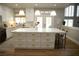 Modern kitchen with a spacious center island, pendant lighting, and sleek countertops at 7444 Grassy Field Ct, Las Vegas, NV 89131