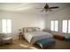 The main bedroom features neutral walls, bright natural light, and a ceiling fan at 7444 Grassy Field Ct, Las Vegas, NV 89131