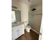 Bathroom featuring updated vanity, a modern shower with glass doors, and wood-look flooring at 800 N Torrey Pines Dr, Las Vegas, NV 89107