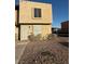 Tan two-story townhome with rock landscaping, steel security door, and window bars at 800 N Torrey Pines Dr, Las Vegas, NV 89107