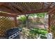 Cozy backyard patio with a grill and lattice overhead, ideal for outdoor dining and relaxation at 8213 Cabin Springs Ave, Las Vegas, NV 89131