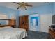 Bedroom with an en-suite bathroom, blue walls, carpet, and oak furniture and fixtures at 8213 Cabin Springs Ave, Las Vegas, NV 89131