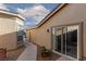 Exterior walkway and slide door feature low maintenance desert landscaping and leads to a peaceful backyard at 8213 Cabin Springs Ave, Las Vegas, NV 89131