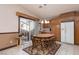 Eat-in kitchen featuring wooden cabinets, track lighting, and white appliances for a functional and cozy space at 8213 Cabin Springs Ave, Las Vegas, NV 89131