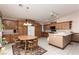 Eat-in kitchen featuring wooden cabinets, track lighting, and white appliances for a functional and cozy space at 8213 Cabin Springs Ave, Las Vegas, NV 89131