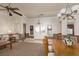 Open-concept living room with beautiful front door, ceiling fan and chandeliers offers comfortable seating arrangements at 8213 Cabin Springs Ave, Las Vegas, NV 89131