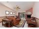 Spacious living room with leather furniture, a ceiling fan, and a sliding glass door to the outdoor area at 8213 Cabin Springs Ave, Las Vegas, NV 89131