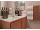 Bathroom featuring a sink with light wood cabinets and neutral-colored decor at 8558 Rumsfield Ct, Las Vegas, NV 89131