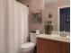 Cozy bathroom featuring a toilet with patterned shower curtain and sink with decor at 8558 Rumsfield Ct, Las Vegas, NV 89131