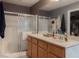 Bathroom featuring a shower and tub, double sinks, and modern fixtures at 8558 Rumsfield Ct, Las Vegas, NV 89131