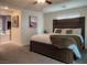 Inviting bedroom with wood headboard, ceiling fan, and ensuite bathroom entrance at 8558 Rumsfield Ct, Las Vegas, NV 89131