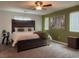 Serene bedroom featuring a wood-style headboard, a comfortable king-size bed, and a ceiling fan at 8558 Rumsfield Ct, Las Vegas, NV 89131