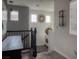 Upstairs hallway with black metal railing, gray carpet, and decorative accents at 8558 Rumsfield Ct, Las Vegas, NV 89131