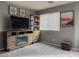 Bright living room featuring wooden entertainment center with fireplace and art, and a large window at 8558 Rumsfield Ct, Las Vegas, NV 89131