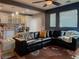 Comfortable living room featuring wood floors, recessed lighting, and a large black leather sectional at 8558 Rumsfield Ct, Las Vegas, NV 89131