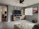 Cozy living room with a ceiling fan and a rustic entertainment center with built-in fireplace, next to the bedroom entrance at 8558 Rumsfield Ct, Las Vegas, NV 89131