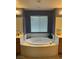 This bathroom features a large tub and is set between two separate vanities at 8558 Rumsfield Ct, Las Vegas, NV 89131