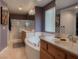 The main bathroom features double vanity, soaking tub and glass shower at 8558 Rumsfield Ct, Las Vegas, NV 89131